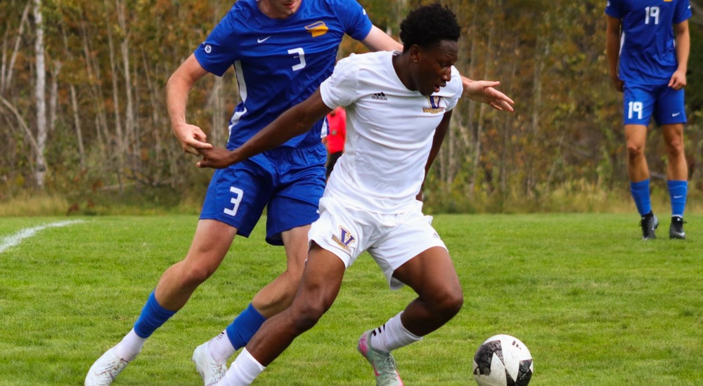 Timi Aliu shields the ball from a TMU player - Tyra Swan